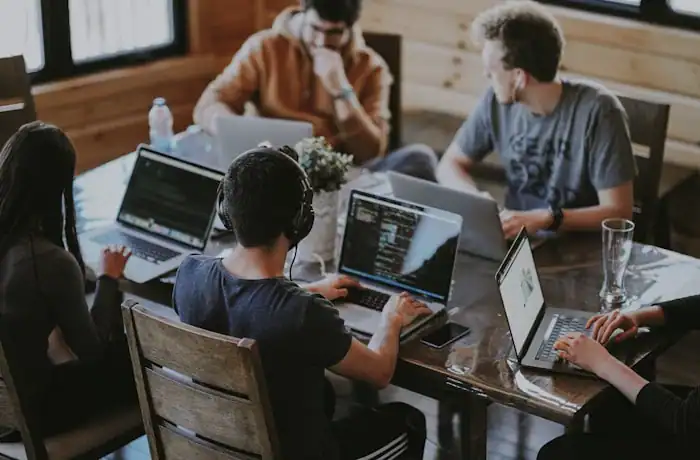 Small team working on gaming content at laptops